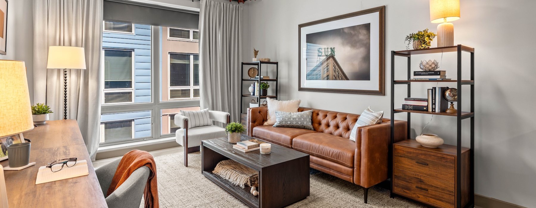 a living room with a couch, tables and chairs